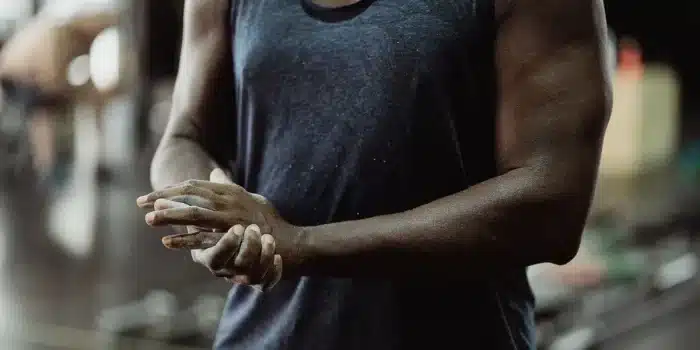 Préparation d'une boisson pré-entraînement en poudre dans un shaker au gym