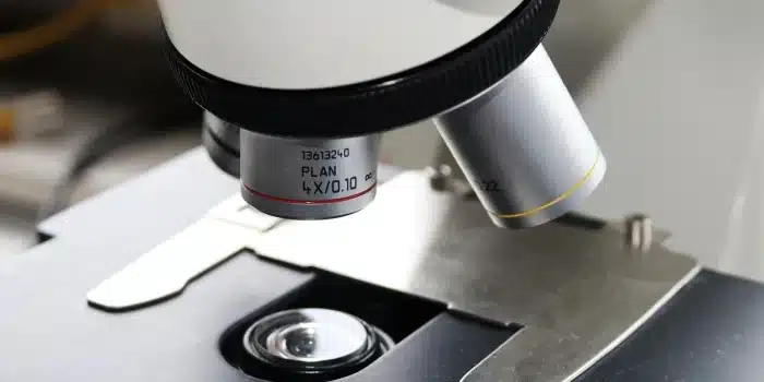 Plan d’un banc de laboratoire en lumière du jour avec lames et microscope flou en arrière-plan